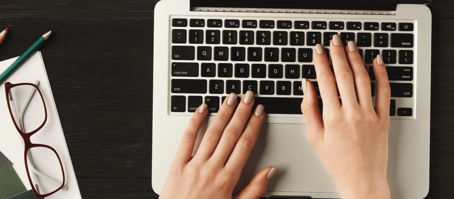 woman-s-hands-on-laptop-keyboard-top-view